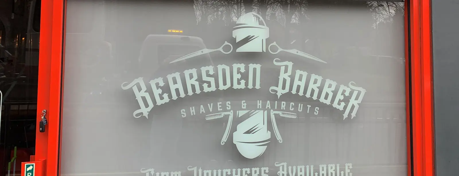 Bearsden Barber shopfront on Drymen Road — etched glass window and red frame